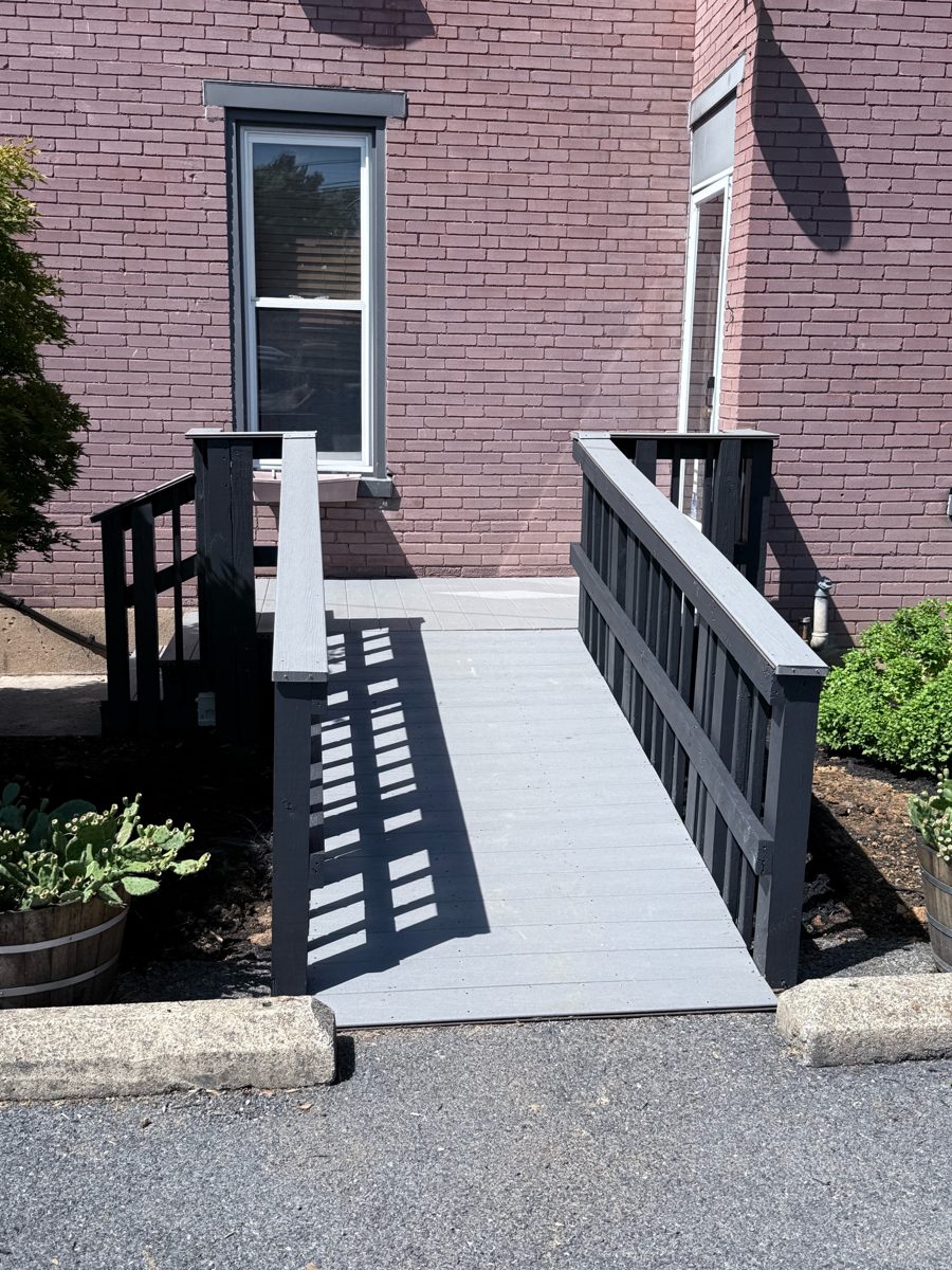 Same ramp after: gray Trex composite decking and railings painted dark gray