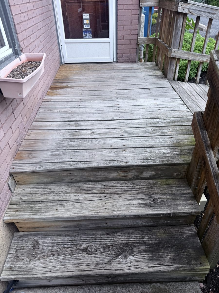 Weathered wood stoop and two steps before repair